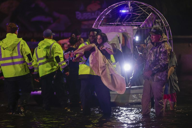 An airboat transports residents rescued from floodwaters in the aftermath of Hurricane Helene on Friday, Sept. 27, 2024 in Crystal River, Fla. (Luis Santana/Tampa Bay Times via AP)