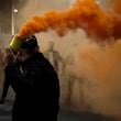 An opposition protester holds a flare during an anti-government rally set up by the opposition, in Tirana, Albania, Monday, Oct. 7, 2024. (AP Photo/Hameraldi Agolli)