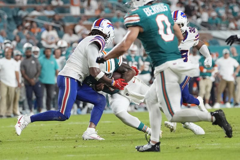 Miami Dolphins quarterback Tua Tagovailoa (1) and Buffalo Bills safety Damar Hamlin (3) collide during the second half of an NFL football game, Thursday, Sept. 12, 2024, in Miami Gardens, Fla. Tagovailoa suffered a concussion on the play. (AP Photo/Lynne Sladky)