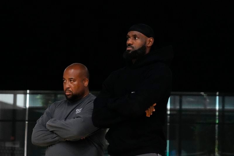 Los Angeles Lakers' LeBron James, right, and Randy Mims attend a news conference held to introduce the team's draft picks, Bronny James and Dalton Knecht, in El Segundo, Calif., Tuesday, July 2, 2024. (AP Photo/Damian Dovarganes)