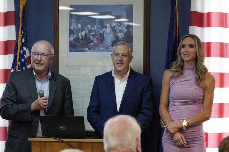 Michigan Republican Party Chairman Pete Hoekstra, left, Republican National Committee Co-chair Michael Whatley and Co-chair Lara Trump take questions at the Oakland County GOP Headquarters, Friday, June 14, 2024 in Bloomfield Hills, Mich. (AP Photo/Carlos Osorio)