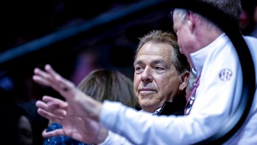 Alabama football coach Nick Saban talks with athletic director Greg Byrne, right, while watching Alabama play against Georgia during the first half of an NCAA college basketball game Saturday, Feb. 18, 2023, in Tuscaloosa, Ala. (AP Photo/Vasha Hunt)