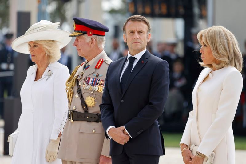 Britain's King Charles III and Britain's Queen Camilla with French President Emmanuel Macron, second right, and hi wife Brigitte Macron, right, attend a commemorative ceremony marking the 80th anniversary of the World War II D-Day" Allied landings in Normandy, at the World War II British Normandy Memorial of Ver-sur-Mer, Thursday, June 6, 2024. Normandy is hosting various events to officially commemorate the 80th anniversary of the D-Day landings that took place on June 6, 1944. (Ludovic Marin/Pool via AP)