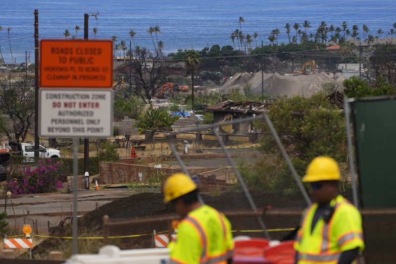 FILE - Crews work to clean debris and repave roads, Saturday, July 6, 2024, in Lahaina, Hawaii. (AP Photo/Lindsey Wasson, File)