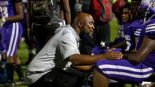 Miller Grove coach Melvin Brown talks with a player during a GHSA high school football game between Stephenson High School and Miller Grove High School at James R. Hallford Stadium in Clarkston, GA., on Friday, Oct. 8, 2021. (Photo/Jenn Finch)