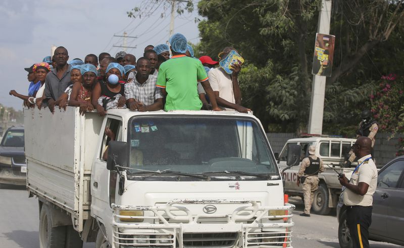 A truck drives past a police officer standing guard outside the airport in Port-au-Prince, Haiti, Thursday, Sept. 5, 2024. (AP Photo/Odelyn Joseph)