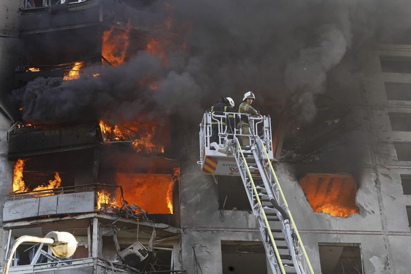 Firefighters tackle a blaze after a Russian aerial bomb struck a multi-story residential building in Kharkiv, Ukraine, Sunday Sept. 15, 2024. (AP Photo/Andrii Marienko)