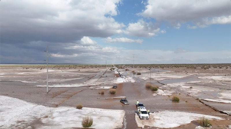 In this photo provided by Mike Bischoff, Vehicles are lined up after flash flooding along Highway 42 near Willard, N.M., on Wednesday, June 19, 2024. (Mike Bischoff @blueskyproductionsutah via AP)