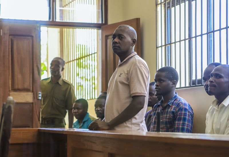 FILE - Extremist evangelical leader Paul Mackenzie, who was arrested on suspicion of telling his followers to fast to death in order to meet Jesus, appears at a court accompanied by some of his followers in Malindi, Kenya on Monday, April 17, 2023. (AP Photo/File)