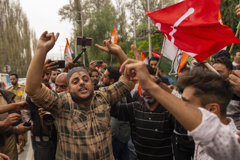 Supporters of National Conference party shout slogans as they celebrate early leads in the election for a local government in Indian controlled Kashmir, Srinagar, Tuesday, Oct. 8, 2024. (AP Photo/Dar Yasin)