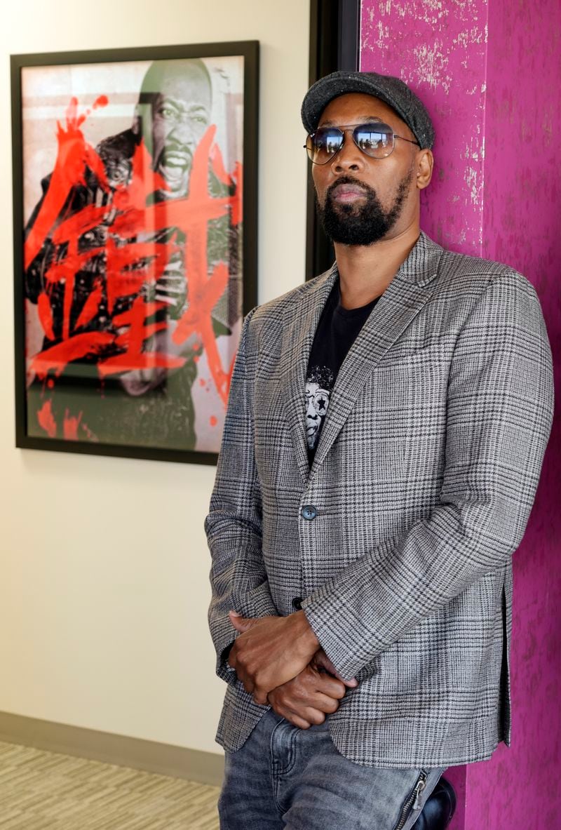 Musician, actor and filmmaker RZA poses for a portrait near a poster for his 2012 film "The Man with the Iron Fists" at his office, Wednesday, Aug. 28, 2024, in Los Angeles. (AP Photo/Chris Pizzello)