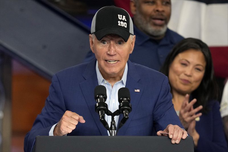 President Joe Biden wears a union hat as he speaks during a visit to the U.A. Local 190 Training Center in Ann Arbor, Mich., Friday, Sept. 6, 2024. (AP Photo/Paul Sancya)