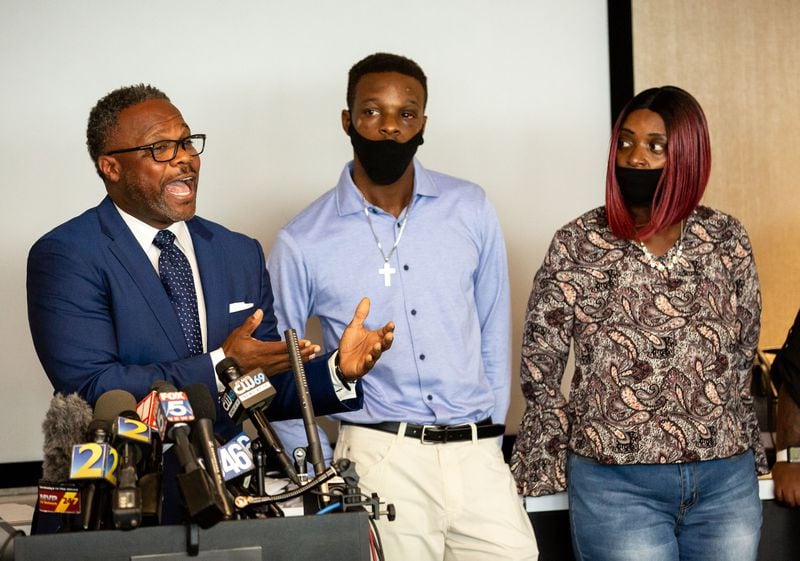  
Roderick Walker, center, and his mother Tywouna Walker stand next to attorney Shean Williams as Williams talks to reporters during a press conference in Atlanta on September 18, 2020. (STEVE SCHAEFER / Special to the AJC) 