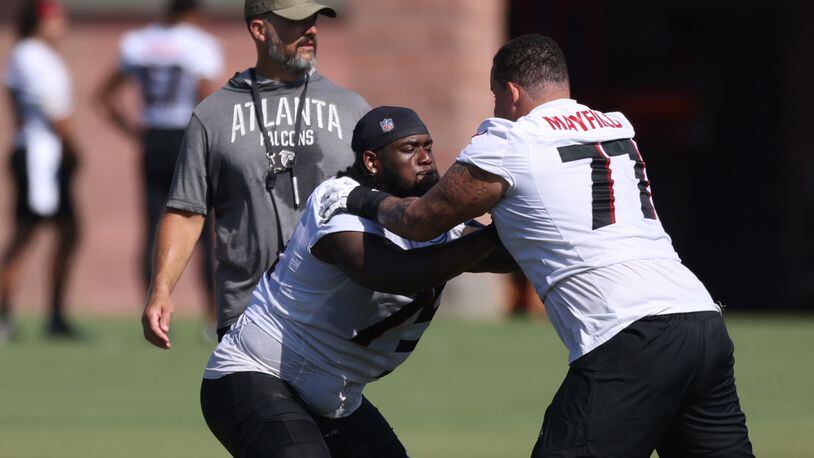 Atlanta Falcons offensive tackle Jalen Mayfield (77) works during