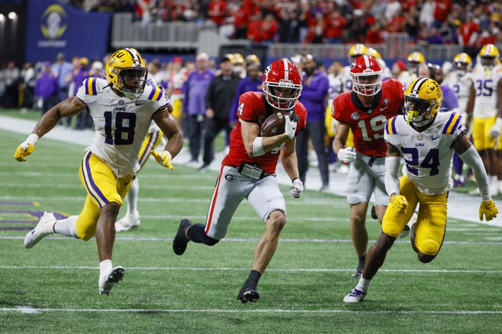 Georgia Bulldogs wide receiver Ladd McConkey (84) runs for a touchdown past LSU Tigers defenders during the second half of the SEC Championship Game at Mercedes-Benz Stadium in Atlanta on Saturday, Dec. 3, 2022. (Bob Andres / Bob Andres for the Atlanta Constitution)