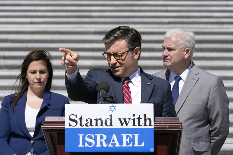 Speaker of the House Mike Johnson, R-La., center, flanked by GOP Conference Chair Elise Stefanik, R-N.Y., left, and Majority Whip Tom Emmer, R-Minn., speak to reporters about President Joe Biden pausing a shipment of bombs to Israel, at the Capitol in Washington, Thursday, May 16, 2024. (AP Photo/J. Scott Applewhite)