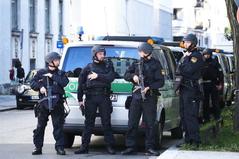 Police officers patrol after police fired shots at a suspicious person near the Israeli Consulate and a museum on the city's Nazi-era history in Munich, Germany, Thursday, Sept. 5, 2024. (AP Photo/Matthias Schrader)