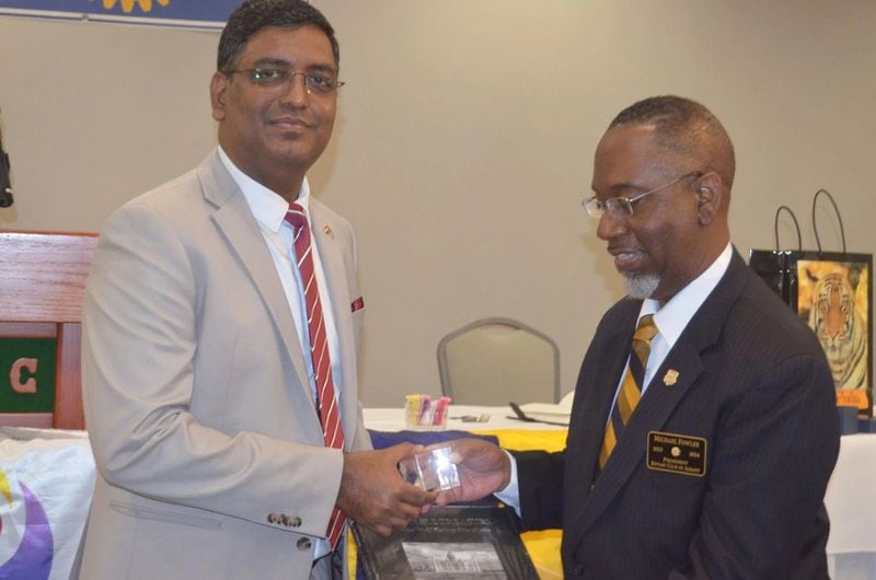 Ramesh Babu Lakshmanan, left, consulate general of the Atlanta-based Consulate General of India, presents a gift to Albany Rotary Club President Michael Fowler. (Photo Courtesy of Alan Mauldin)