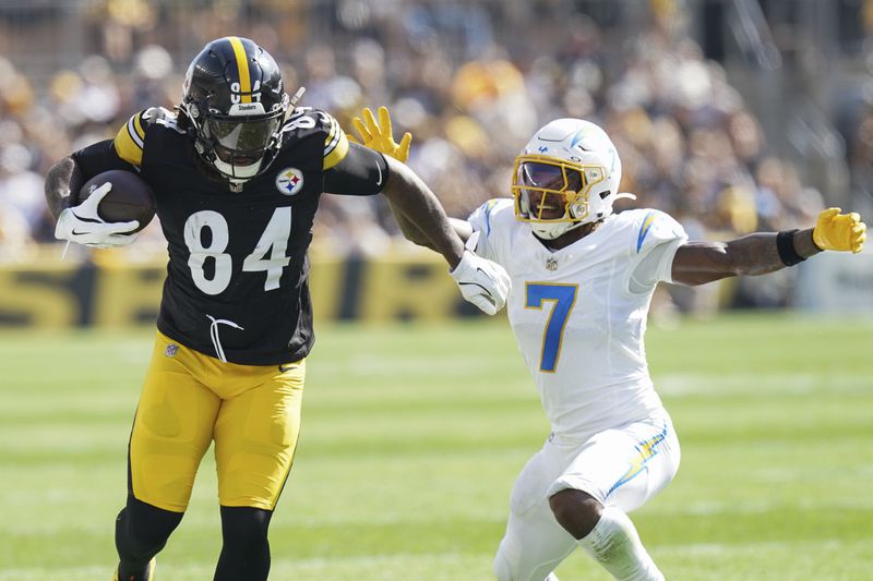 Pittsburgh Steelers running back Cordarrelle Patterson, left, runs with the ball against Los Angeles Chargers cornerback Kristian Fulton, right, during the second half of an NFL football game, Sunday, Sept. 22, 2024, in Pittsburgh. (AP Photo/Matt Freed)