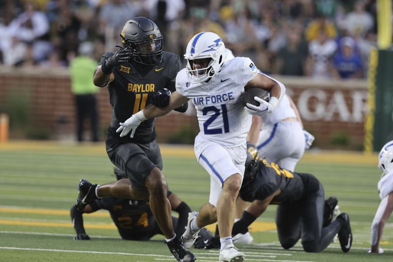 Air Force wide receiver Cade Harris attempts to slip past Baylor linebacker Keaton Thomas during the first half of an NCAA college football game, Saturday, Sept. 14, 2024, in Waco, Texas. (Rod Aydelotte/Waco Tribune-Herald via AP)