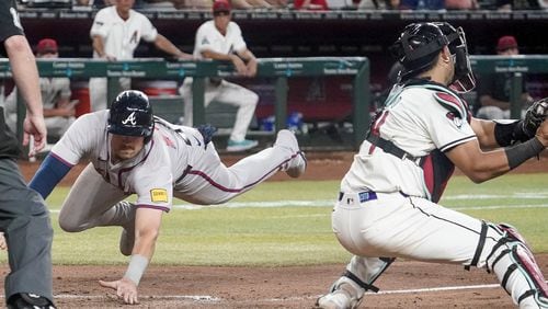 Austin Riley scores the winning run in the 11th inning of Monday's win over the Diamondbacks.