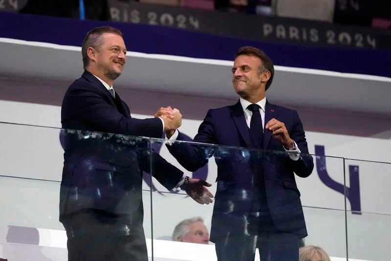 French President Emmanuel Macron, right, and President of the International Paralympic Committee Andrew Parsons shake hands during the closing ceremony for the 2024 Paralympics, Sunday, Sept. 8, 2024, in Paris, France. (AP Photo/Michel Euler)