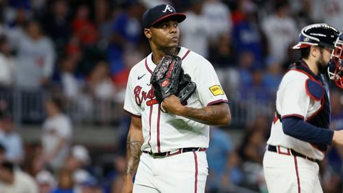 Atlanta Braves pitcher Raisel Iglesias looks at the score after being the removed after allowing five runs during the ninth inning against the Los Angeles Dodgers at Truist Park on Sunday, Sept. 15, 2024, in Atlanta. 
(Miguel Martinez/ AJC)