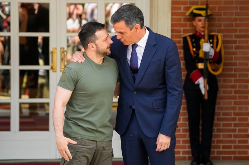 Ukrainian President Volodymyr Zelenskyy, left, is welcomed by Spain's Prime Minister Pedro Sanchez at the Moncloa palace in Madrid on Monday, May 27, 2024. (AP Photo/Paul White)