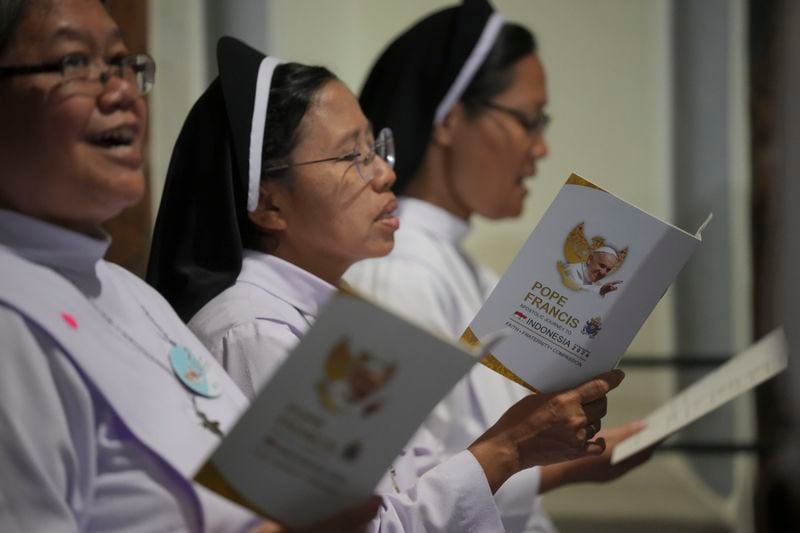 Nuns pray before the arrival of Pope Francis at the Cathedral of Our Lady of the Assumption, in Jakarta, Indonesia, Wednesday, Sept. 4, 2024. (AP Photo/Dita Alangkara, Pool)