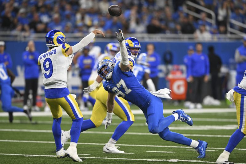 Detroit Lions defensive end Aidan Hutchinson (97) pressures Los Angeles Rams quarterback Matthew Stafford (9) during the first half of an NFL football game in Detroit, Sunday, Sept. 8, 2024. (AP Photo/David Dermer)