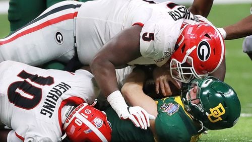 Georgia defensive lineman Julian Rochester (top) and Malik Herring level Baylor quarterback Charlie Brewer in the Sugar Bowl Wednesday, Jan. 1, 2020, at the Mercedes-Benz Superdome in New Orleans.