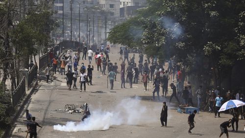 Students clash with riot police during a protest against a quota system for government jobs, in Dhaka, Bangladesh, Thursday, July 18, 2024. (AP Photo/Rajib Dhar)