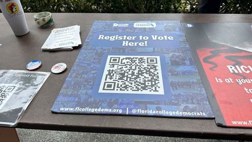 FILE - A QR code sign is displayed at Florida Atlantic University April 11, 2024, in Boca Raton, Fla. for students to register to vote. A three-year-old Biden executive order asking federal agencies to prioritize voter registration is being targeted by Republicans as this year's presidential election draws closer and has become entangled in the politics of immigration. (AP Photo/Cody Jackson, File)