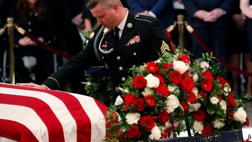 FILE - Jimmy McCain, son of Sen. John McCain, R-Ariz., pauses at his father's casket during ceremonies honoring McCain at the U.S. Capitol Rotunda in Washington, Aug. 31, 2018. Jimmy McCain has registered as a Democrat and will vote for Kamala Harris for President in 2024. (Kevin Lamarque/Pool Photo via AP)