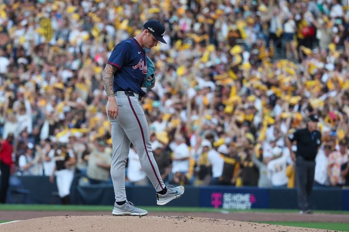 Atlanta Braves pitcher AJ Smith-Shawver (32) grooms the pitching mound after a 2-RBI home run to San Diego Padres’ Fernando Tatis Jr. during the first inning of National League Division Series Wild Card Game One at Petco Park in San Diego on Tuesday, Oct. 1, 2024.   (Jason Getz / Jason.Getz@ajc.com)