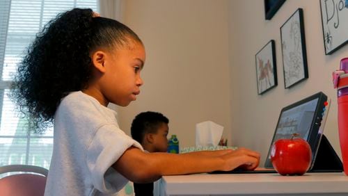 Ayra Murphy, 9, plays a computer game on a tablet at her home in Suwanee on Monday, July 12, 2021. Murphy was placed in a gifted education program two years ago at Sycamore Elementary. (Christine Tannous / christine.tannous@ajc.com)