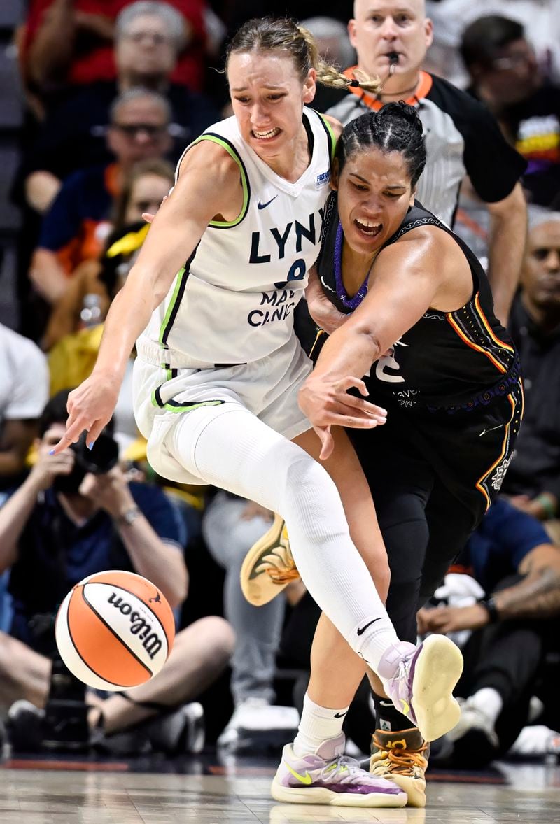 Minnesota Lynx forward Alanna Smith, left, is fouled by Connecticut Sun forward Brionna Jones, right, during the first half of a WNBA basketball semifinal game, Friday, Oct. 4, 2024, in Uncasville, Conn. (AP Photo/Jessica Hill)