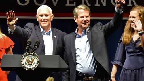 November 1, 2018 Dalton -  Vice President Mike Pence and GOP gubernatorial candidate Brian Kemp wave to supporters at Dalton Convention Center in Dalton on Thursday, November 1, 2018. The nationally-watched Georgia race for governor is about to get even more attention. Vice President Mike Pence is headed to Georgia on Thursday for a trio of events in conservative areas for Brian Kemp. Democrats are countering with a visit by Oprah Winfrey, who will appear with Stacey Abrams at a pair of town hall meetings. HYOSUB SHIN / HSHIN@AJC.COM