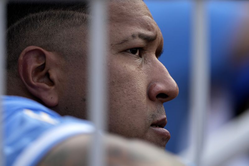 Kansas City Royals' Salvador Perez watches from the dugout during the fourth inning of a baseball game against the San Francisco Giants Saturday, Sept. 21, 2024, in Kansas City, Mo. (AP Photo/Charlie Riedel)