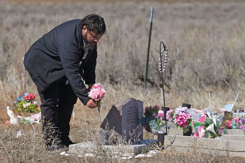 Shoshone-Paiute tribal member Michael Hanchor visits his mother’s grave, March 15, 2024, in Owyhee, Nev., on the Duck Valley Indian Reservation that straddles the Nevada-Idaho border. (AP Photo/Rick Bowmer)