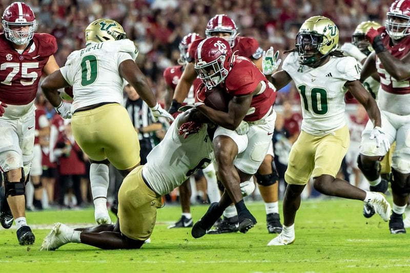 Alabama running back Jam Miller (26) runs the ball against South Florida linebacker Jamie Pettway (6) during the first half of an NCAA college football game, Saturday, Sept. 7, 2024, in Tuscaloosa, Ala. (AP Photo/Vasha Hunt)