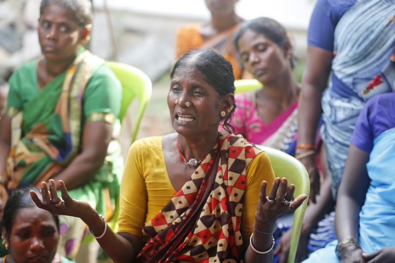A relative of a man, who died after drinking illegally brewed liquor, cries at home in Kallakurichi district of the southern Indian state of Tamil Nadu, India, Thursday, June 20, 2024. The state's chief minister M K Stalin said the 34 died after consuming liquor that was tainted with methanol, according to the Press Trust of India news agency. (AP Photo/R. Parthibhan)