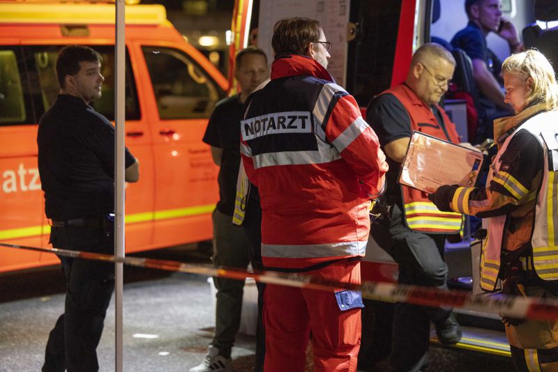 Emergency services near the scene where people were killed and injured in an attack at a festival in Solingen, western Germany, the German dpa news agency reported, Friday, Aug. 23, 2024. (Gianni Gattus/dpa via AP)