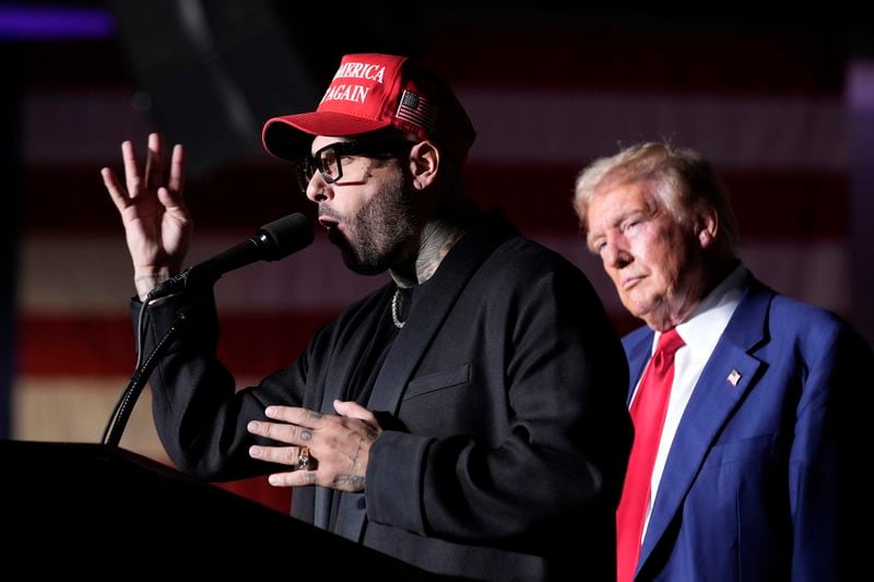 Nicky Jam speaks as Republican presidential nominee former President Donald Trump listens during a campaign event at the World Market Center, Friday, Sept.13, 2024, in Las Vegas. (AP Photo/Alex Brandon)