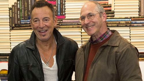 Bruce Springsteen, left, and Craig Schneider pose for a photo at the 2nd & Charles bookstore in Kennesaw on Friday. The famous rocker (Springsteen, that is) was there to meet about 1,200 fans who bought tickets for the event, which included a signed copy of his new autobiography. (Photo by Phil Skinner)