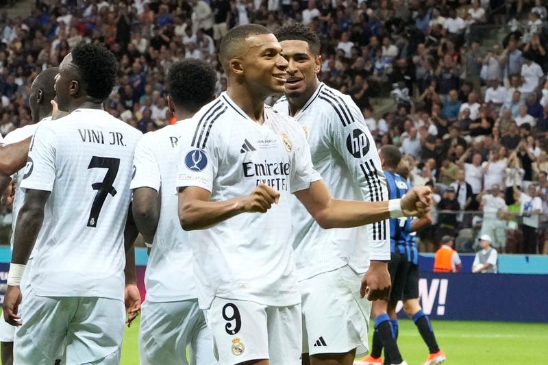 Real Madrid's Kylian Mbappe, second from right, celebrates after scoring his side's second goal during the UEFA Super Cup Final soccer match between Real Madrid and Atalanta at the Narodowy stadium in Warsaw, Poland, Wednesday, Aug. 14, 2024. (AP Photo/Czarek Sokolowski)