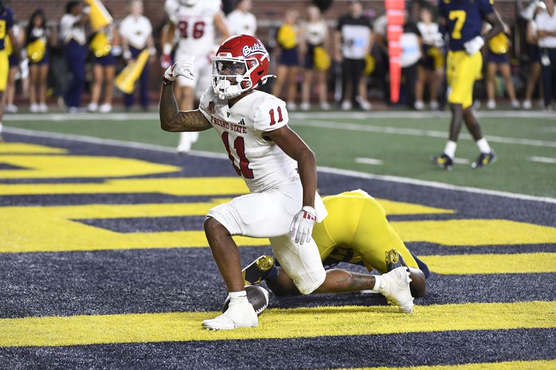 Fresno State wide receiver Raylen Sharpe celebrates his touchdown against Michigan in the second half of an NCAA college football game, Saturday, Aug. 31, 2024, in Ann Arbor, Mich. (AP Photo/Jose Juarez)