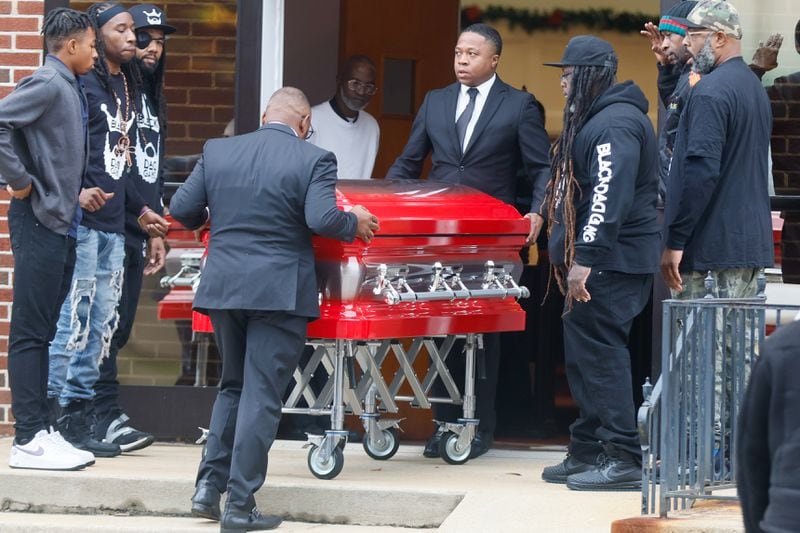  The casket of 12-year-old Zyion Charles is moved into the First Iconium Baptist Church Saturday, December 10, 2022. Family, friends and community members wearing red, white and black sat at a solemn gathering Saturday as they faced the bright red casket as his picture sat atop. (Steve Schaefer/steve.schaefer@ajc.com)