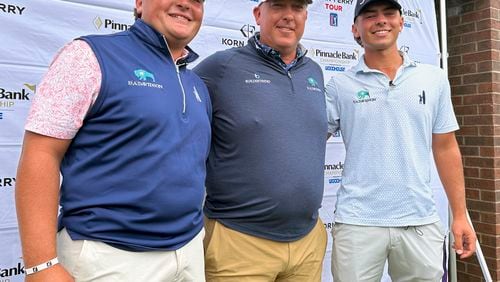 Scott Gutschewski is flanked by his sons, Luke, left, and Trevor ahead of the Korn Ferry Tour’s Pinnacle Bank Championship golf tournament, Tuesday, Aug. 6, 2024, in Omaha, Neb. (AP Photo/Eric Olson)