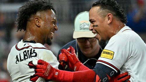 Braves second baseman Ozzie Albies (left) celebrates with shortstop Orlando Arcia after the win. (Hyosub Shin / Hyosub.Shin@ajc.com)